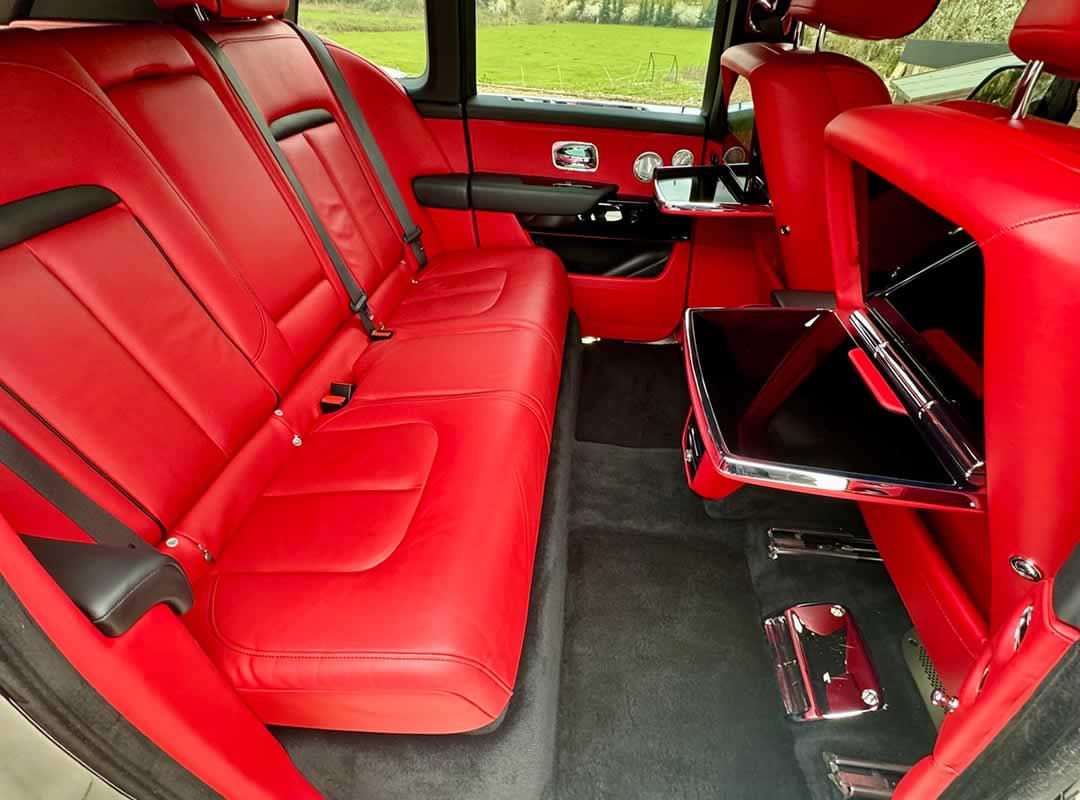 Black Rolls-Royce Cullinan red interior rear seating and drop down TV screens